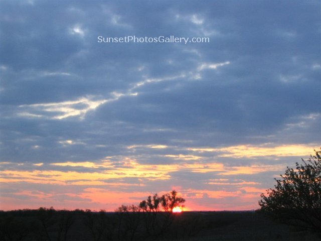 Colorful Sunset clouds - blue, pink, orange and yellow colors in beautiful cloudy sunset sky