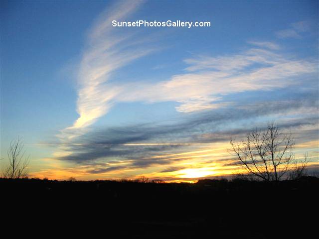 Orange and Blue Color Nebraska Midwest Country Sunrise sky with Jet Trails in Clouds 