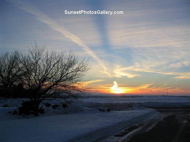 Nebraska Midwest Colorful Sunset and clouds - red, orange and blue color sunset with " beamÂ " in sky + jet trail